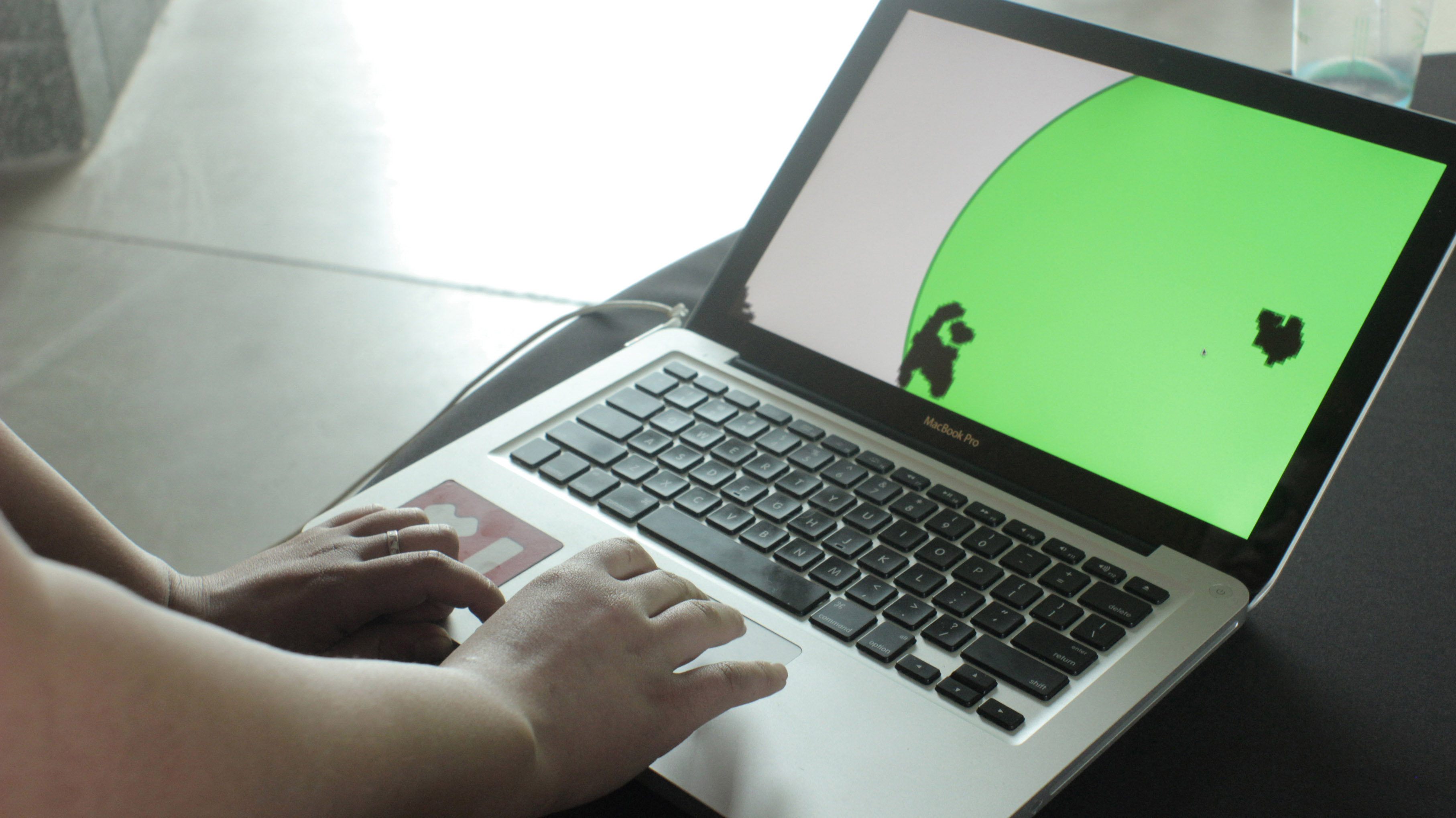 View full size version of a laptop with a green circle on the screen